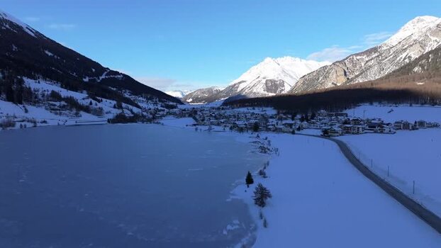 Aerial view of Graun im Vinschgau village and frozen lake Italy. Aerial view of Graun im Vinschgau village and frozen lake Italy.