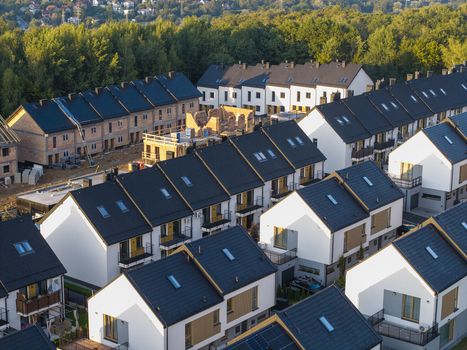 Aerial view of modern row houses and residential development under construction with sloped roofs and white facades in Wieliczka Lesser Poland Voivode Poland.