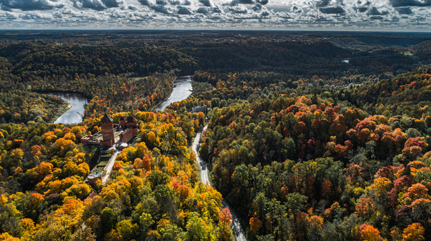 Aerial view of Turaida Castle surrounded by vibrant autumn forest and the winding Gauja River in Sigulda Sigulda Municipality Latvia. Aerial view of Turaida Castle surrounded by vibrant autumn forest and the winding Gauja River in Sigulda Sigulda Municipality Latvia.