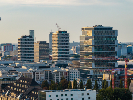 Aerial view of modern high rise office buildings and construction cranes in the urban landscape of Berlin Berlin Germany. Aerial view of modern high rise office buildings and construction cranes in the urban landscape of Berlin Berlin Germany.