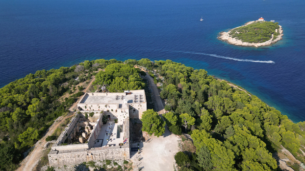 Aerial view of Fort George surrounded by lush pine forests and the deep blue Adriatic Sea in Vis Splitsko dalmatinska Croatia. Aerial view of Fort George surrounded by lush pine forests and the deep blue Adriatic Sea in Vis Splitsko dalmatinska Croatia.