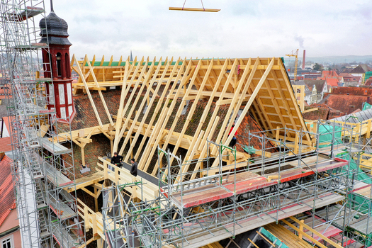 Aerial view of Rathaus Forchheim under renovation with new wooden roof trusses scaffolding and workers in Forchheim Bayern Germany. Aerial view of Rathaus Forchheim under renovation with new wooden roof trusses scaffolding and workers in Forchheim Bayern Germany.