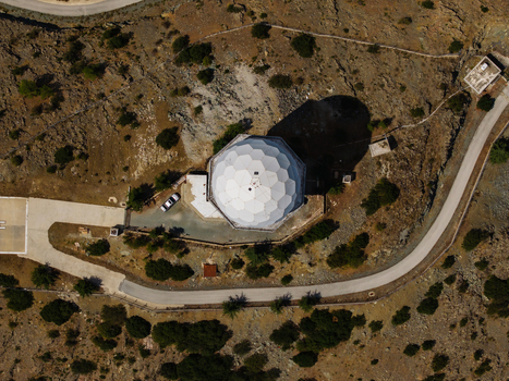 Aerial view of the Kionia radar dome situated on a rocky mountain peak surrounded by sparse vegetation and a winding road in Lazanias Lefkosia Cyprus. Aerial view of the Kionia radar dome situated on a rocky mountain peak surrounded by sparse vegetation and a winding road in Lazanias Lefkosia Cyprus.