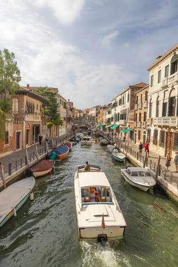 Venice Italy 21 September 2026 View of a canal with motorboats and water taxis navigating between historic buildings under a bright sky. Venice Italy 21 September 2026 View of a canal with motorboats and water taxis navigating between historic buildings under a bright sky.