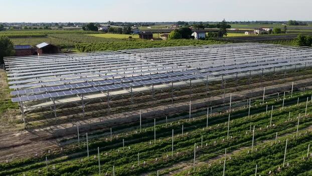 Aerial view of solar panels over agricultural fields Italy.