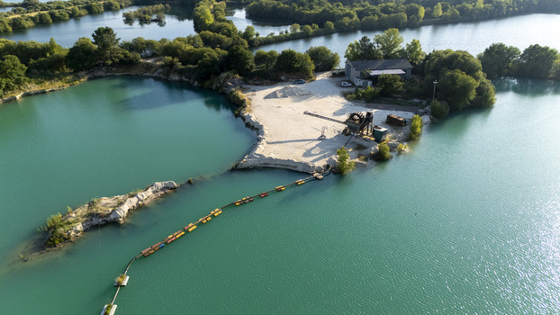 Aerial view of Extraccion de aridos Lima SL sand extraction site with turquoise water pools industrial equipment and greenery in Vilarino das Poldras Ourense Spain. Aerial view of Extraccion de aridos Lima SL sand extraction site with turquoise water pools industrial equipment and greenery in Vilarino das Poldras Ourense Spain.