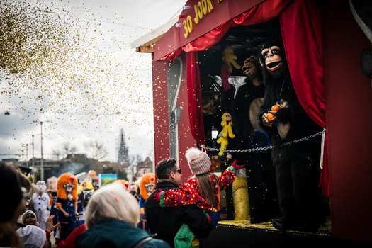 Basel Switzerland 10 March 2025 View of a vibrant Fasnacht parade float featuring costumed figures and a shower of golden confetti creating a festive atmosphere against the city backdrop. Basel Switzerland 10 March 2025 View of a vibrant Fasnacht parade float featuring costumed figures and a shower of golden confetti creating a festive atmosphere against the city backdrop.