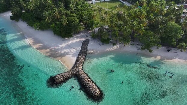 Aerial view of a tropical beach and stone breakwater Maldives. Aerial view of a tropical beach and stone breakwater Maldives.