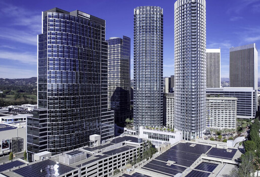 Aerial view of modern skyscrapers and residential towers in Century City featuring glass facades and solar panel installations on rooftops in Los Angeles California United States.