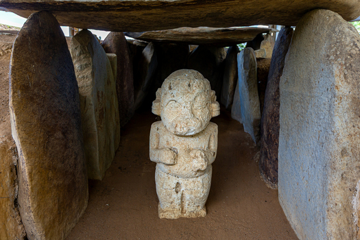 View of a pre Columbian stone statue inside a megalithic tomb chamber at San Agustin Archaeological Park San Agustin Huila Colombia.