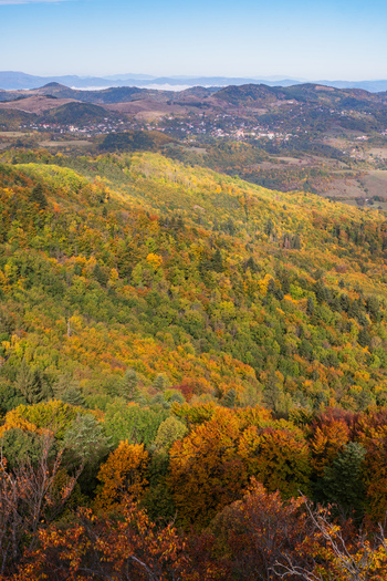 Aerial view of Sitno mountain covered in vibrant autumn foliage with dense forests and distant hills in Ilija Banska Bystrica Region Slovakia. Aerial view of Sitno mountain covered in vibrant autumn foliage with dense forests and distant hills in Ilija Banska Bystrica Region Slovakia.