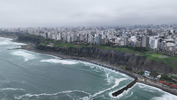 Aerial view of the dramatic coastal cliffs and urban skyline of Miraflores overlooking the Pacific Ocean in Barranco Provincia de Lima Peru. Aerial view of the dramatic coastal cliffs and urban skyline of Miraflores overlooking the Pacific Ocean in Barranco Provincia de Lima Peru.