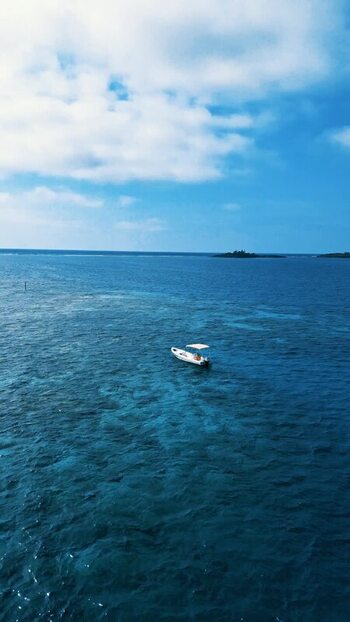 Aerial view of a boat on turquoise coral reef waters Honduras. Aerial view of a boat on turquoise coral reef waters Honduras.