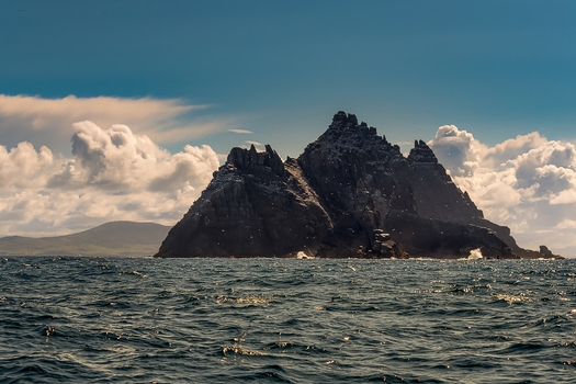 View of the jagged peaks of Great Skellig rising from the Atlantic Ocean under a cloudy sky County Kerry Ireland. View of the jagged peaks of Great Skellig rising from the Atlantic Ocean under a cloudy sky County Kerry Ireland.