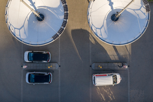 Aerial view of the ENTEGA Charging Station with circular canopies and electric vehicles at charging points in Darmstadt Hessen Germany. Aerial view of the ENTEGA Charging Station with circular canopies and electric vehicles at charging points in Darmstadt Hessen Germany.