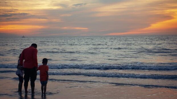 View of a family on the beach at sunset in Cox s Bazar Bangladesh.