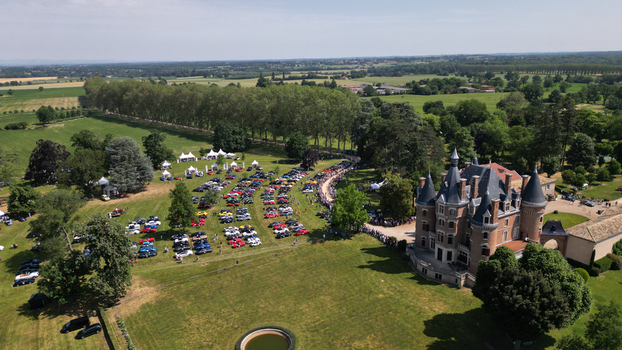 Francheleins France 04 June 2023 Aerial view of Chateau de Vataneins with a car show on the lawn featuring rows of vehicles people and lush green countryside. Francheleins France 04 June 2023 Aerial view of Chateau de Vataneins with a car show on the lawn featuring rows of vehicles people and lush green countryside.