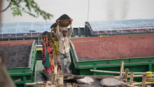 View of workers carrying coal baskets at Aminbazar Bangladesh.