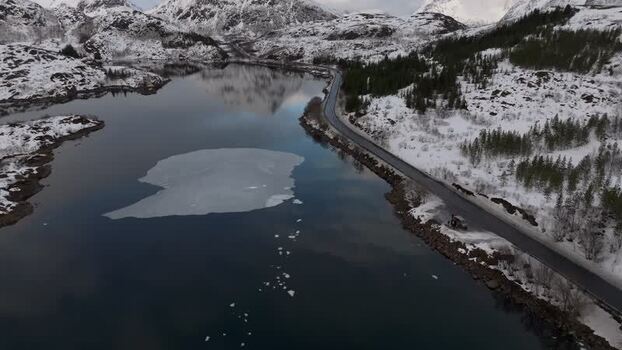 Aerial view of Lofoten mountains and icy lake Norway.