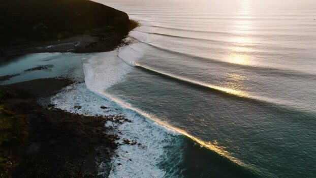 Aerial view of ocean waves at golden hour in Raglan New Zealand. Aerial view of ocean waves at golden hour in Raglan New Zealand.