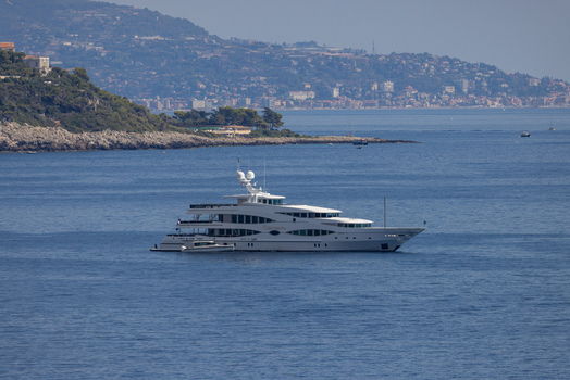 Aerial view of a luxury yacht anchored in the Mediterranean Sea near the coastline of Monaco City Monaco Monaco.