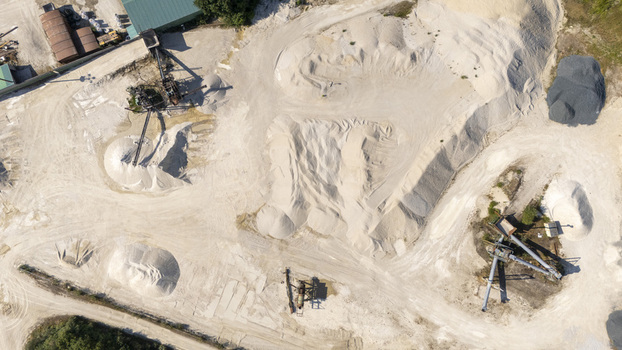 Aerial view of Extraccion de aridos Lima SL a sand and gravel extraction site featuring industrial machinery and piles of sand in Vilarino das Poldras Ourense Spain. Aerial view of Extraccion de aridos Lima SL a sand and gravel extraction site featuring industrial machinery and piles of sand in Vilarino das Poldras Ourense Spain.