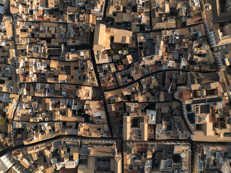 Aerial view of the historic Island of Ortigia with its dense terracotta rooftops and narrow winding streets in Syracuse Sicily Italy. Aerial view of the historic Island of Ortigia with its dense terracotta rooftops and narrow winding streets in Syracuse Sicily Italy.
