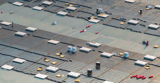 Loriol sur Drome Auvergne Rhone Alpes France 26 July 2026 Aerial view of a modern industrial warehouse under construction showing roofing works skylights and waterproofing membrane.
