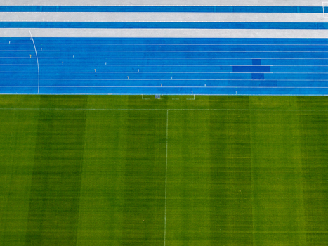 Berlin Germany 26 September 2026 Aerial view of Olympiastadion Berlin featuring a vibrant blue running track and a lush green grass field.