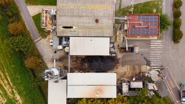 Aerial view of the Depuratore di San Giuliano Milanese Ovest water treatment facility with industrial buildings solar panels and surrounding vegetation in Rancate Lombardia Italy. Aerial view of the Depuratore di San Giuliano Milanese Ovest water treatment facility with industrial buildings solar panels and surrounding vegetation in Rancate Lombardia Italy.