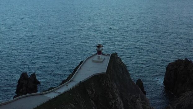Aerial view of Faro do Cabo Ortegal on rocky cliffs Spain.
