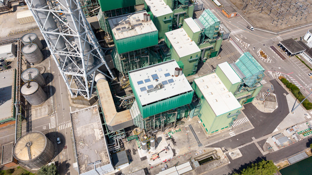 Aerial view of the TTEP Tavazzano thermal power plant and TERNA electrical substation with industrial buildings and cooling towers in Tavazzano con Villavesco Lombardy Italy.