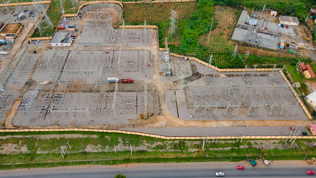 Aerial view of TCN SubStation Katampe featuring electrical transformers power lines and metal structures within a fenced area in Abuja Federal Capital Territory Nigeria.