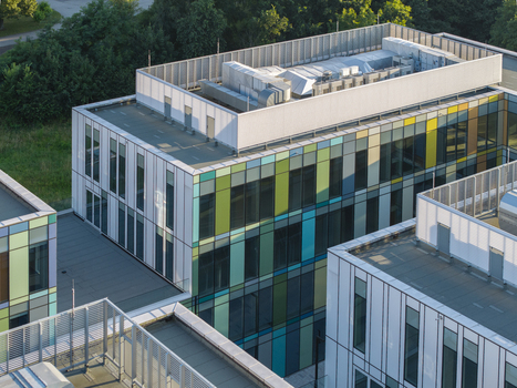 Aerial view of the ai data center cooling system on the rooftop of a modern building with colorful glass panels in Krakow Lesser Poland Voivode Poland. Aerial view of the ai data center cooling system on the rooftop of a modern building with colorful glass panels in Krakow Lesser Poland Voivode Poland.