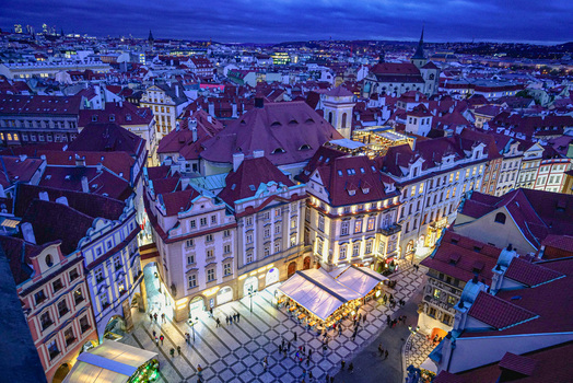 Aerial view of the historic Old Town Square with its iconic red rooftops illuminated buildings and cobblestone streets at dusk in Prague Prague Czechia. Aerial view of the historic Old Town Square with its iconic red rooftops illuminated buildings and cobblestone streets at dusk in Prague Prague Czechia.