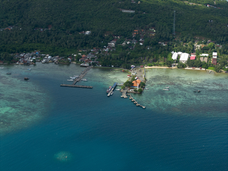 Aerial view of the ferry harbour a vibrant tapestry where the deep blue sea meets the verdant coastline Karimunjawa Jawa Tengah Indonesia. Aerial view of the ferry harbour a vibrant tapestry where the deep blue sea meets the verdant coastline Karimunjawa Jawa Tengah Indonesia.