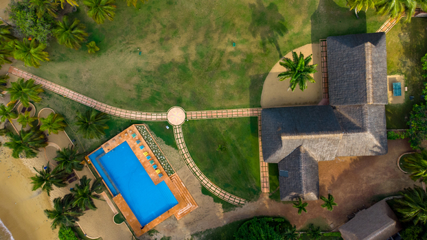 Axim Western Region Ghana 09 February 2023 Aerial view of Lou Moon Resort Eco Luxury featuring a swimming pool thatched roof buildings and lush tropical gardens. Axim Western Region Ghana 09 February 2023 Aerial view of Lou Moon Resort Eco Luxury featuring a swimming pool thatched roof buildings and lush tropical gardens.