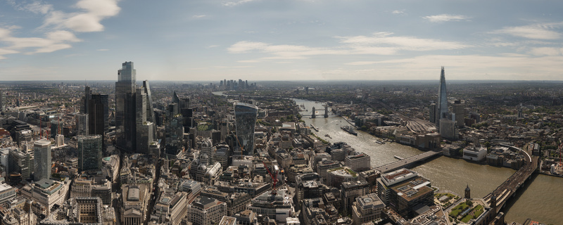 Aerial view of The Fenchurch Building The Shard and Tower Bridge along the River Thames under a bright sky London England United Kingdom. Aerial view of The Fenchurch Building The Shard and Tower Bridge along the River Thames under a bright sky London England United Kingdom.