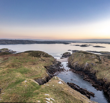 Aerial view of the rugged coastline and rocky inlet at sunset in Kincasslagh County Donegal Ireland. Aerial view of the rugged coastline and rocky inlet at sunset in Kincasslagh County Donegal Ireland.