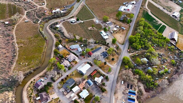 Aerial view of the winding river snaking through the landscape vineyards sprawling and houses clustered together a symphony of nature and human touch Palisade Colorado USA. Aerial view of the winding river snaking through the landscape vineyards sprawling and houses clustered together a symphony of nature and human touch Palisade Colorado USA.
