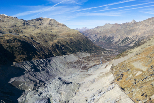 Aerial view of the rugged terrain meets the Morteratsch Glacier where icy blues contrast sharply with the earthy browns of the surrounding mountains Morteratsch Glacier Grisons Switzerland. Aerial view of the rugged terrain meets the Morteratsch Glacier where icy blues contrast sharply with the earthy browns of the surrounding mountains Morteratsch Glacier Grisons Switzerland.
