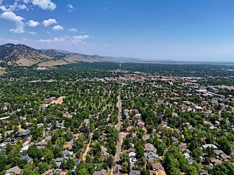 Aerial view of Chautauqua Park and the surrounding residential area with the Flatirons in the background under a clear blue sky in Boulder Colorado United States. Aerial view of Chautauqua Park and the surrounding residential area with the Flatirons in the background under a clear blue sky in Boulder Colorado United States.