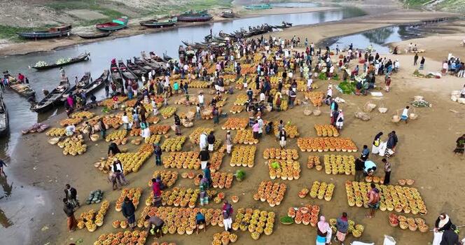 Aerial view of a bustling riverside market in Sylhet Bangladesh.