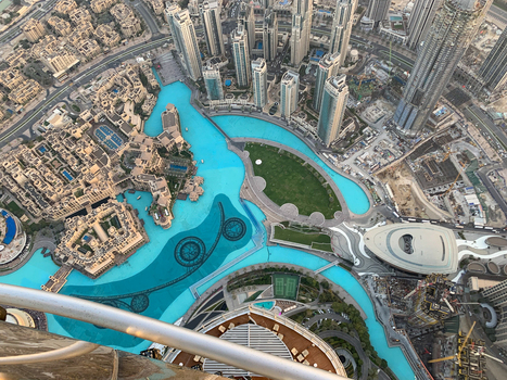 View of the turquoise Burj Khalifa Lake surrounded by modern skyscrapers and traditional Arabian architecture in Dubai Dubai United Arab Emirates. View of the turquoise Burj Khalifa Lake surrounded by modern skyscrapers and traditional Arabian architecture in Dubai Dubai United Arab Emirates.