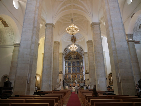 View of the interior of the Se de Portalegre cathedral featuring stone columns ornate chandeliers and the main altar in Portalegre Portalegre District Portugal.