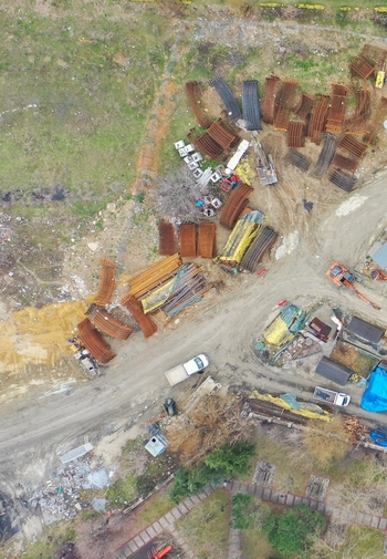 Aerial view of a construction storage yard with stacks of curved metal rebar heavy machinery and a white truck on a dirt ground in Avcilar Istanbul Turkiye. Aerial view of a construction storage yard with stacks of curved metal rebar heavy machinery and a white truck on a dirt ground in Avcilar Istanbul Turkiye.