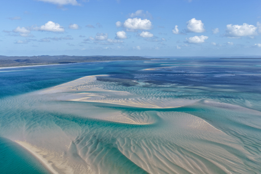 Aerial view of sandbanks and turquoise waters in Moreton Bay near Amity Point Minjerribah North Stradbroke Island with ripples in the sand in Amity Point Queensland Australia. Aerial view of sandbanks and turquoise waters in Moreton Bay near Amity Point Minjerribah North Stradbroke Island with ripples in the sand in Amity Point Queensland Australia.