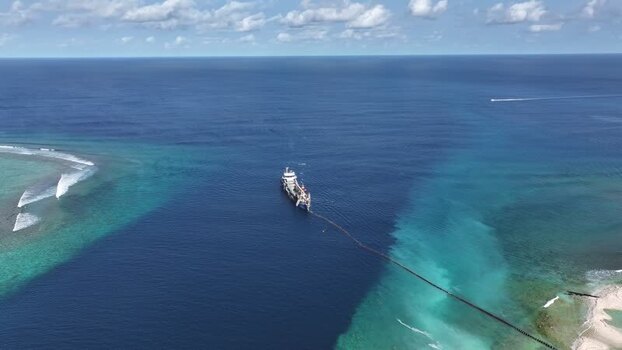Aerial view of a dredging ship near a coral reef Maldives. Aerial view of a dredging ship near a coral reef Maldives.