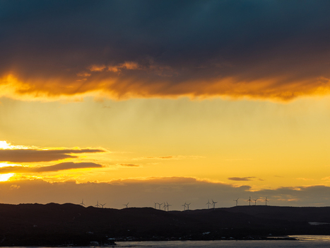 Aerial view of wind turbines on the ridge at Torndirrup National Park during a golden sunset with dramatic clouds over the coastline in Albany Western Australia Australia. Aerial view of wind turbines on the ridge at Torndirrup National Park during a golden sunset with dramatic clouds over the coastline in Albany Western Australia Australia.