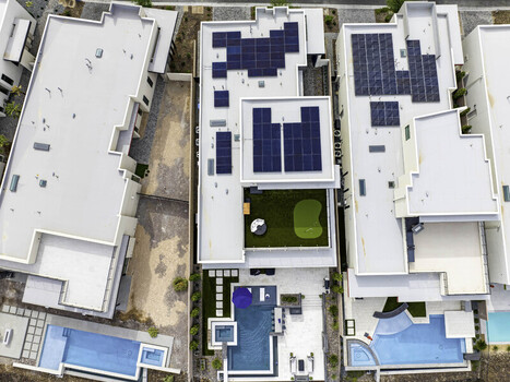 Los Angeles California United States 13 October 2023 Aerial view of modern homes with rooftop solar panels a private putting green and swimming pools in a suburban neighborhood. Los Angeles California United States 13 October 2023 Aerial view of modern homes with rooftop solar panels a private putting green and swimming pools in a suburban neighborhood.